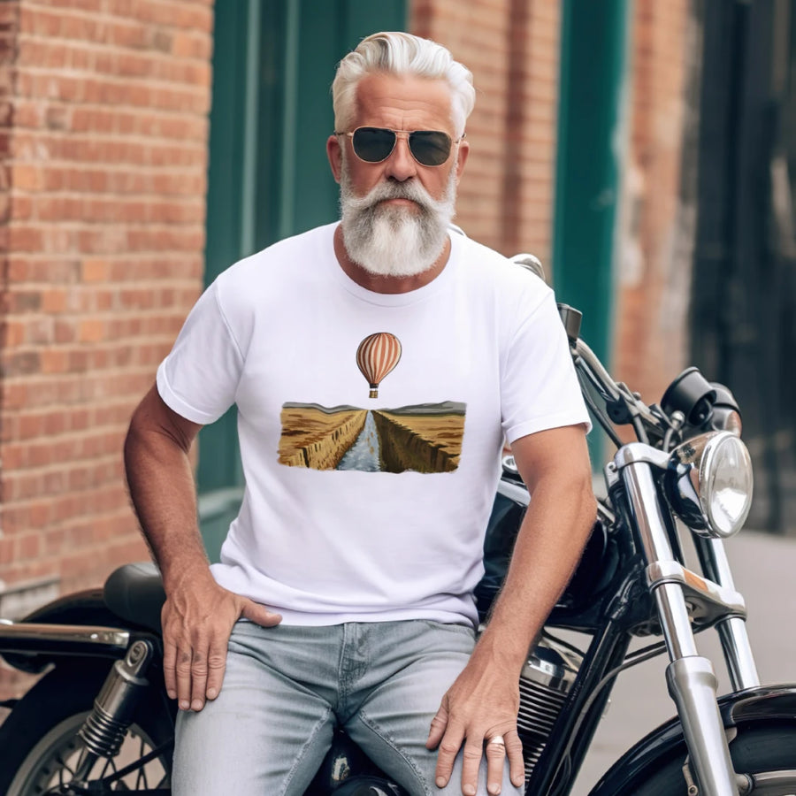 Man sitting on a motorcycle wearing a white t-shirt with a graphic design.
