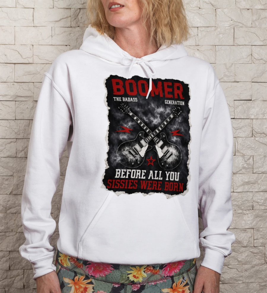 Person wearing a white hoodie with a graphic design on a stone wall background