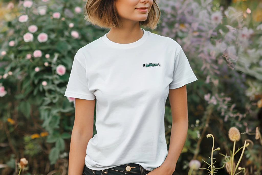 Person wearing a white t-shirt with a logo in front of flowers