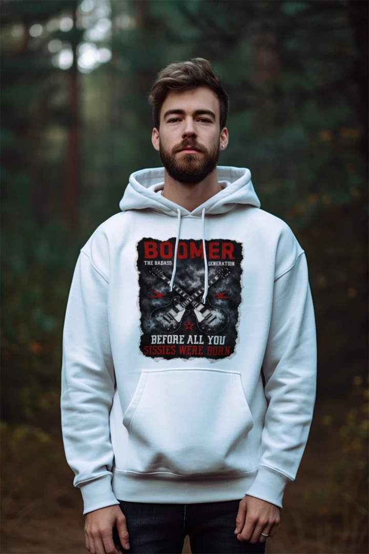 Man wearing a white hoodie with graphic design and text in a forest setting